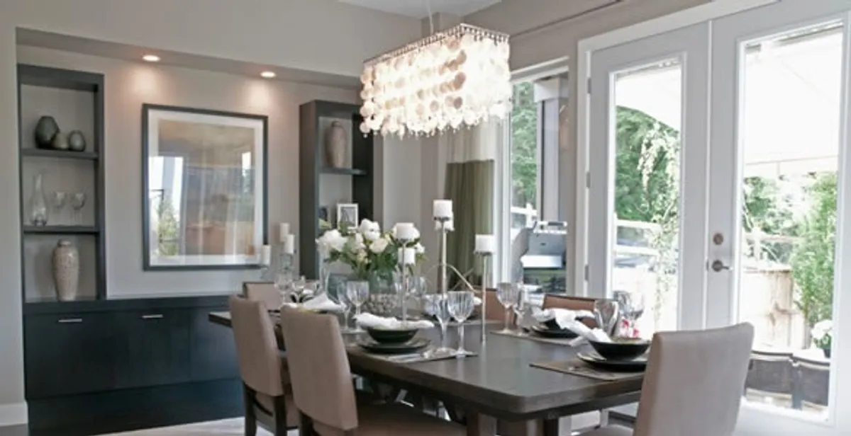 Elegant dining room chandelier installation above table in Cincinnati, OH